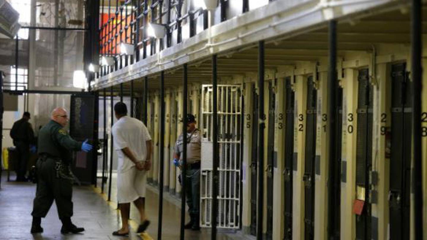A condemned inmate is led out of his east block cell on death row at San Quentin State Prison. Photo / AP