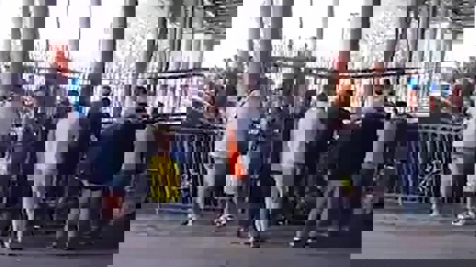People attend to the injured after a woman drove into pedestrians at the Westfield Mall in Manukau on March 20. / Supplied still from video