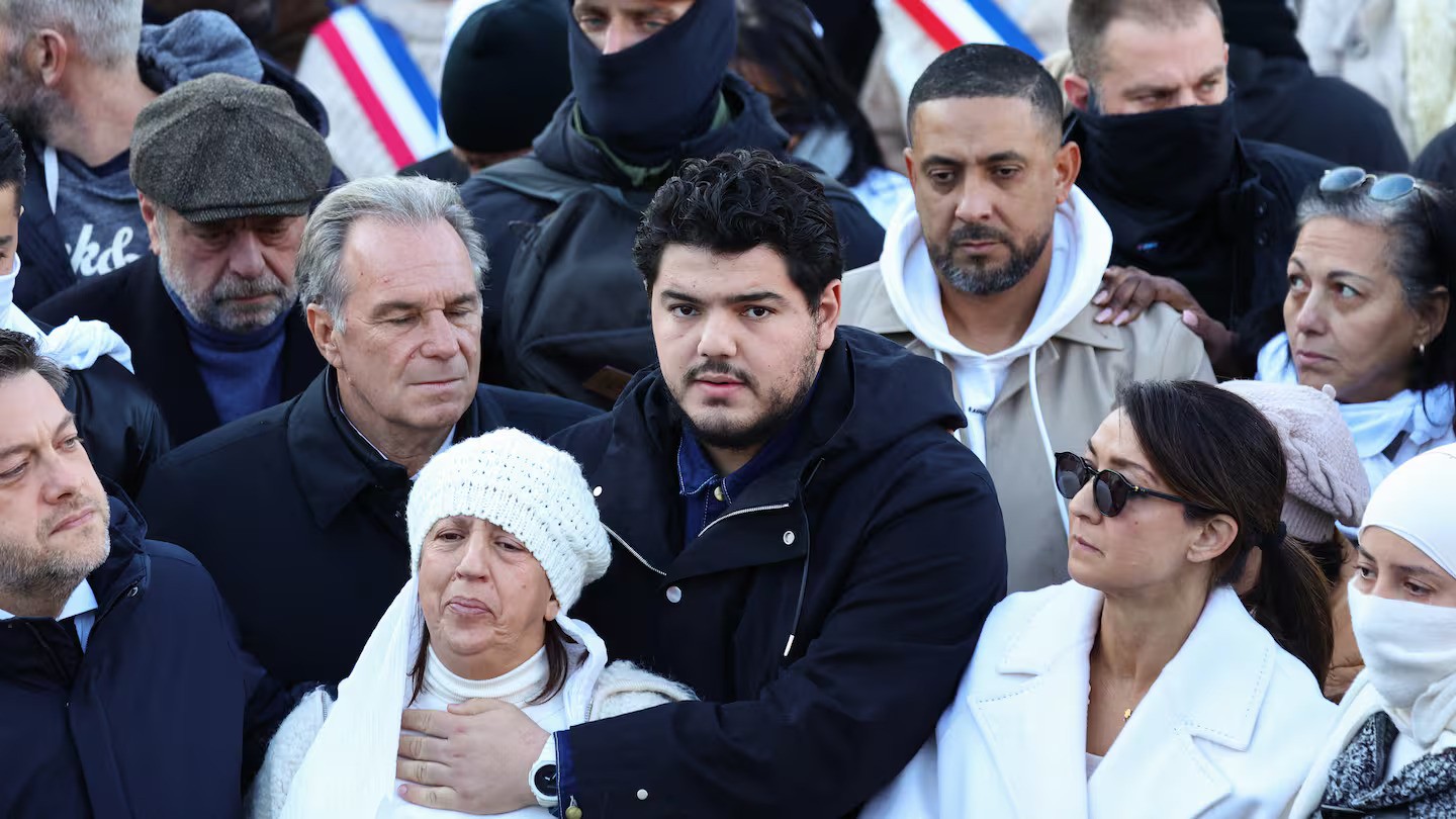 French anti-drug activist Amine Kessaci (centre), his mother Ouassila Benhamdi Kessaci (second left), Marseille's Mayor Benoit Payan (left), observe a moment of silence during a gathering in tribute to Mehdi Kessaci at the roundabout where he was murdered and to protest against drug trafficking, in Marseille, southern France. Photo / Clement Mahoudeau, AFP