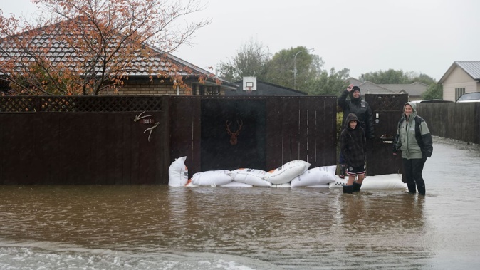 Residents of the Canterbury town of Doyleston are sandbagging their homes as the rain continues to fall. Photo / George Heard