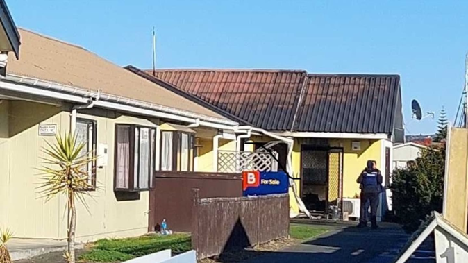 A specialist fire investigator is on the scene of a suspicious house fire in Onekawa on Wednesday morning. Photo / Gary Hamilton-Irvine