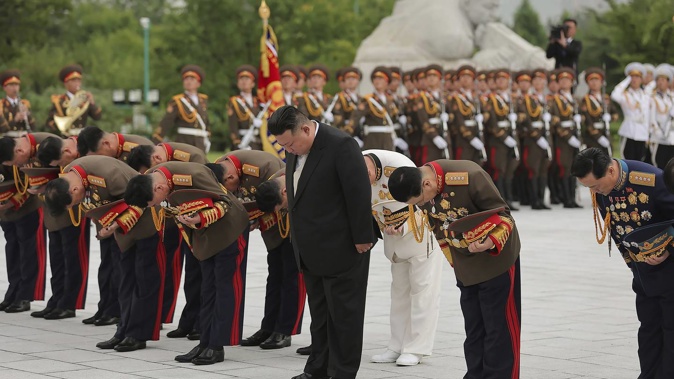 In this photo provided by the North Korean government, North Korean leader Kim Jong Un (centre, front) visits a "Liberation War" martyrs' cemetery in Pyongyang, North Korea. Photo / AP