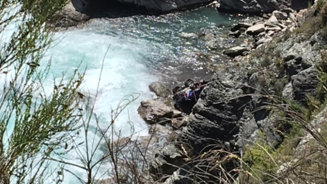The car crashed down the bank before stopping near the Kawarau River. Photo / Guy Williams, ODT