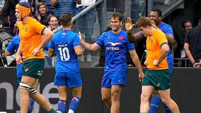 France's Damain Penau, centre, celebrates with teammates scoring a try against the Wallabies. Photo / AP