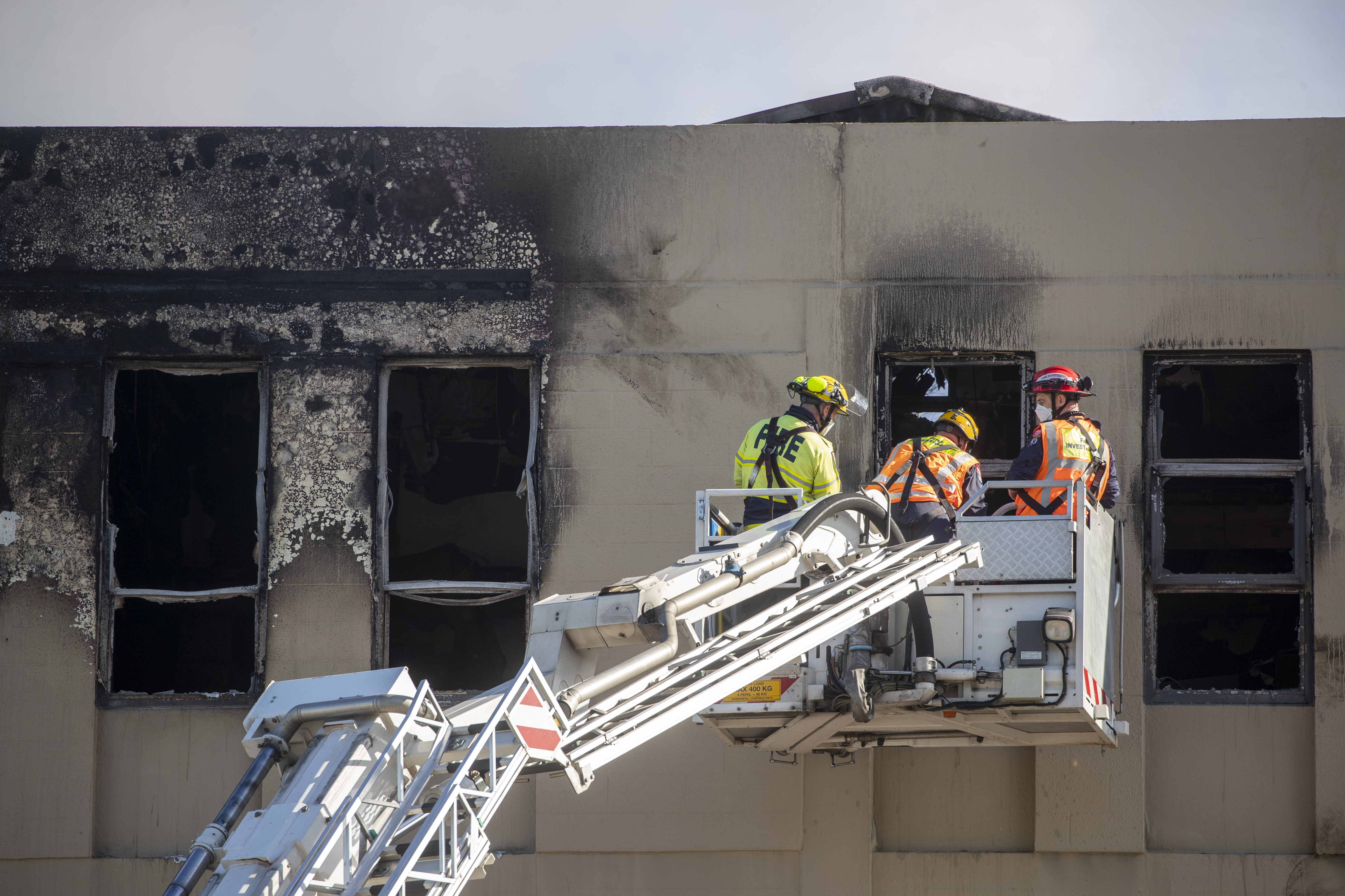 FENZ fire investigation officers photographing the third floor of Loafers Lodge hostel on Adelaide Road. Image / Mark Mitchell
