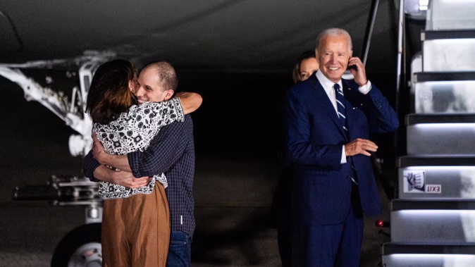 Evan Gershkovich hugs Ella Milman after returning to the United States from detention in Russia. President Biden and Vice President Harris met the released hostages upon their return at Joint Base Andrews. Photo / The Washington Post