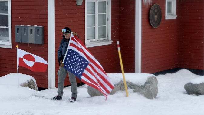 A person protests in front of the American Consulate in Nuuk, Greenland, following Trump's repeated threats to take over the island. Photo / Getty Images