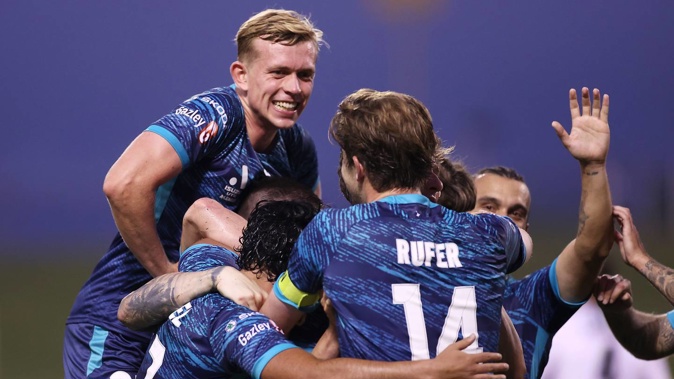 Gary Hooper, of the Phoenix, celebrates with teammates after scoring a goal. (Photo / Photosport)