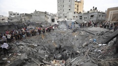 Palestinians survey the rubble of a destroyed building after an Israeli airstrike in Deir al Balah, Gaza Strip. Photo / AP