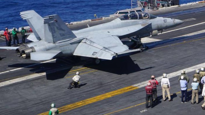 An F-18 Hornet fighter jet prepares to take off from the flight deck of the aircraft carrier USS Carl Vinson. (Photo / File)