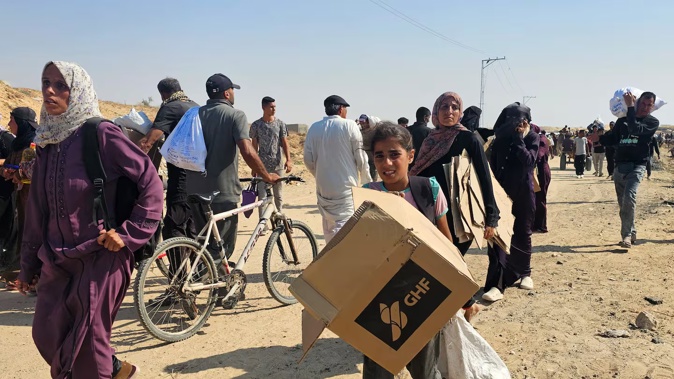 Displaced Palestinians walk to receive humanitarian aid packages from a US-backed foundation in Rafah in the southern Gaza Strip. Photo / AFP
