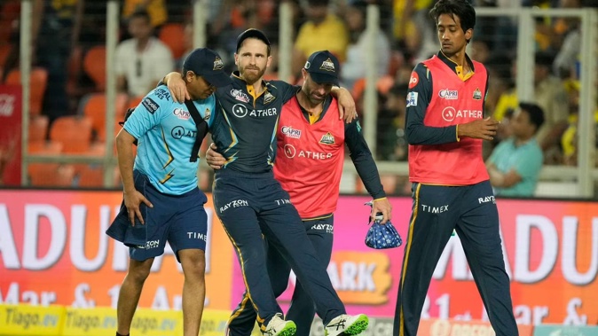 Gujarat Titan's Kane Williamson is carried off the field after injuring his right knee. Photo / AP
