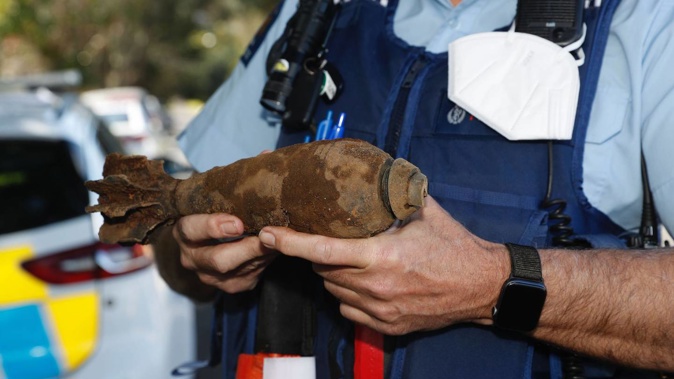 Inspector Kerry Watson holding the mortar bomb, which was inert. Photo / Dean Purcell