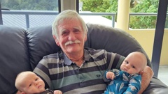 Russell ferry owner and skipper Bill Elliott with two of his grandchildren. Photo / Supplied