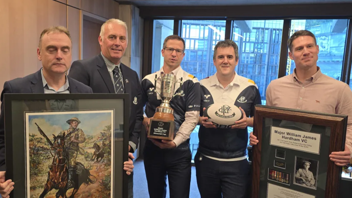 William Harding VC painting and Hardham Cup. (L to R) Mark Brewer, NZ Remembrance Army Trustee; Brent Pritchard, Petone Rugby President; Chris Penk Veterans Minister; Chris Bishop Minister of Sport and Tim Ewing Jarvine NZRA Board Member. Photo / Supplied