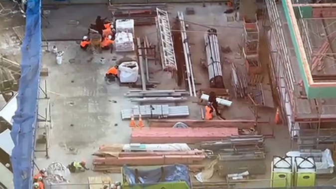 AOS and construction workers on the roof of the Deloitte building in Downtown Auckland as a shooting incident is responded to on July 20.