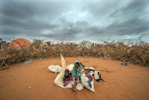 A Somali woman and child wait to be given a spot to settle at a camp for displaced people on the outskirts of Dollow, Somalia on Tuesday, Sept. 20, 2022. A new report says an estimated 43,000 people died amid the longest drought on record in Somalia last year and half of them likely were children.