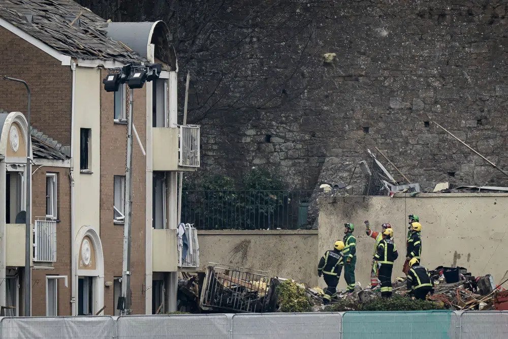 Specialist rescue teams at the scene of an explosion and fire at an apartment building, in St Helier, Jersey, Channel Islands, Sunday, Dec. 11, 2022. An explosion and fire in an apartment building has killed at least three people and left several missing. The chief officer of the States of Jersey Police said “around a dozen” residents were missing on Saturday following the blast in the town of St Helier. (Aaron Chown/PA via AP)