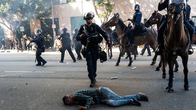 LAPD officers on horseback clash with protesters during protests after a series of immigration raids on June 08, 2025 in Los Angeles, California. (Photo by Spencer Platt/Getty Images)