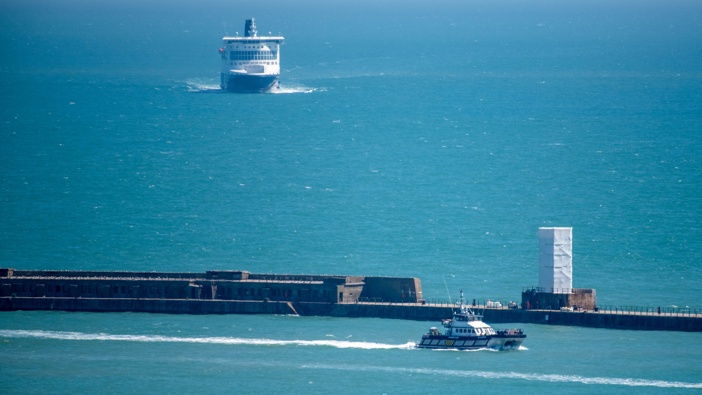 A British Border Force vessel, right, carrying migrants enters the Port of Dover in Dover, UK, on Monday, Aug. 5, 2024. Photo / Getty