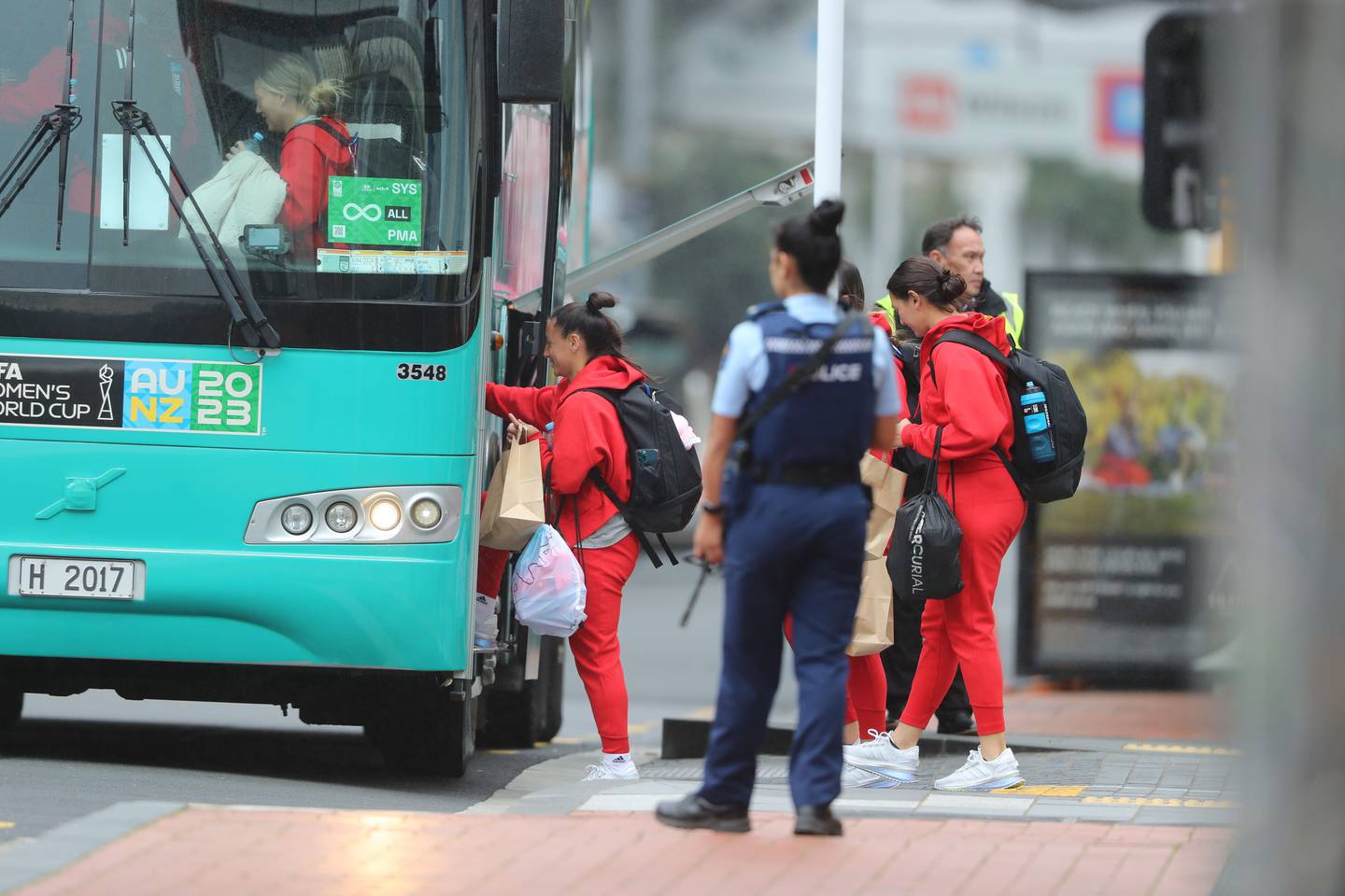 A police officer stands guard as members of the Phillipines team leave downtown Auckland shortly after the shootings.