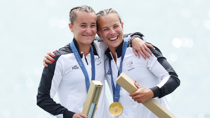 Gold medalists Lisa Carrington and Alicia Hoskin of Team New Zealand celebrate on the podium during the Women's Kayak Double 500m Final on day fourteen of the Olympic Games Paris 2024 at Vaires-Sur-Marne Nautical Stadium on August 09, 2024 in Paris, France. (Photo by Justin Setterfield/Getty Images)