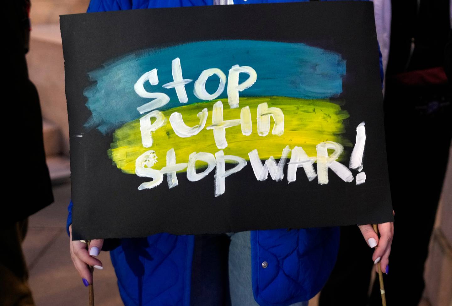 A woman holds a banner in Belgrade, Serbia, at a protest against the mobilisation announced by Russian President Vladimir Putin. Photo / Darko Vojinovic, AP