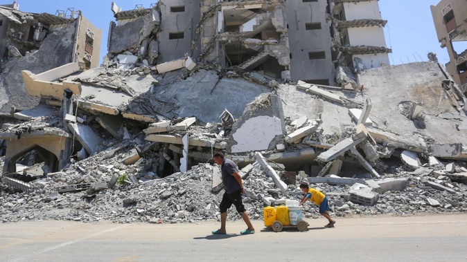 Israeli army issues an evacuation warning to Palestinians in the Hamad area of Khan Yunis, Gaza, Palestinians who remain in the area continue to struggle to survive under difficult conditions amidst the rubble of destroyed buildings on August 12, 2024. Photo / Getty Images