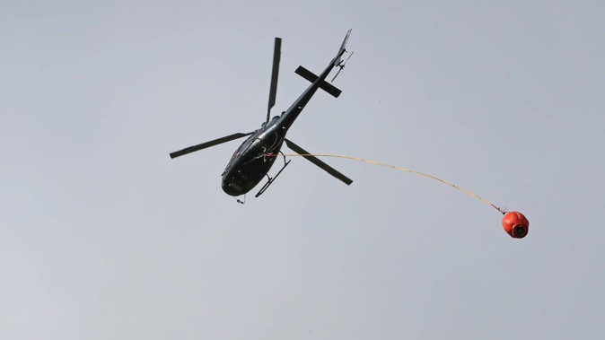 A helicopter and rural fire crews were called in to assist in putting out a scrub fire near Waiouru yesterday. (Photo / Bevan Conley)