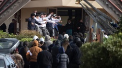 The body of 16-year-old Kyah Kennedy is carried into the Te Rau Aroha Marae in Bluff for his tangi. Photo / George Heard