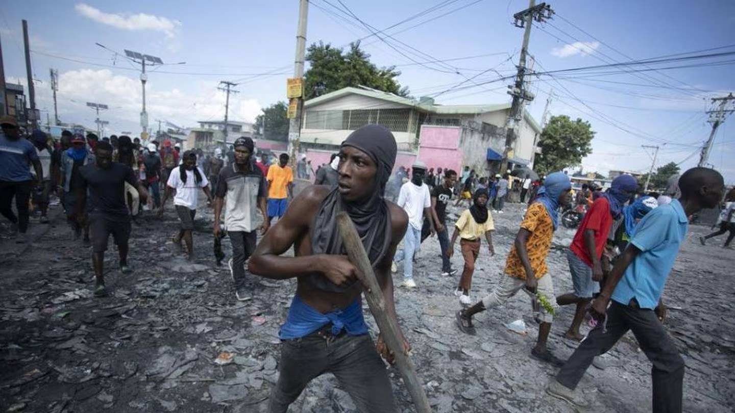 A protester carries a piece of wood emulating a weapon in Port-au-Prince, Haiti. Photo / AP
