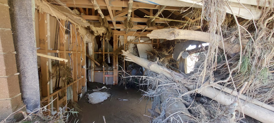 Giant logs speared through property in Eskdale, Napier during last week's cyclone. Photo / Queensland Fire and Emergency Service.
