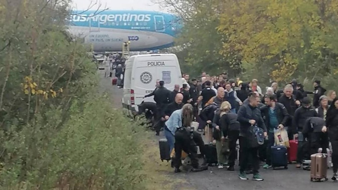 Passengers on an Aerolineas Argentinas A330 were disembarked and marched into the woods following a bomb threat. Photo / Diego Aramayo; Twitter
