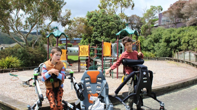 Kash Edmonds and Cyrus Dahl with the new inclusive swing, which will be installed at the Lorna Irene Reserve Playground in Raumati. Photo / Rosalie Willis