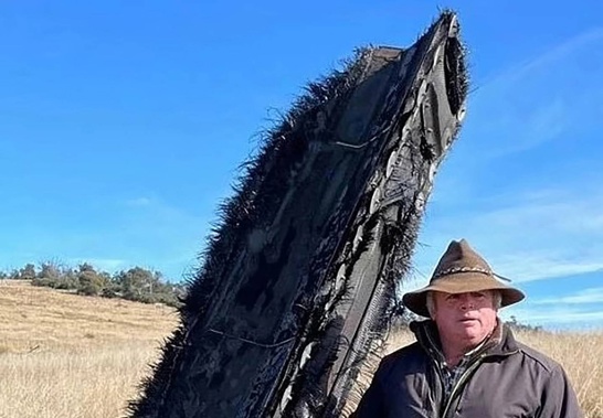 Mick Miners with the space junk that landed on his NSW farm. Photo / Mick Miners