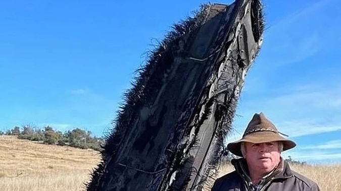 Mick Miners with the space junk that landed on his NSW farm. Photo / Mick Miners