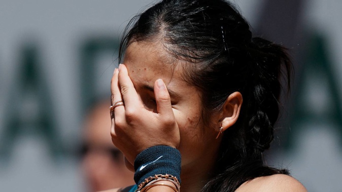 Britain's Emma Raducanu hides her face as she plays Aliaksandra Sasnovich of Belarus during their second round match of the French Open. Photo / AP