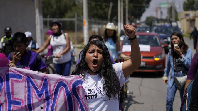Roxana Ruiz is photographed shouting slogans during a march in memory of Diana Velazquez, who was making a call outside her home in 2017 when she was disappeared, raped and killed, in Chimalhuacan. Photo / AP