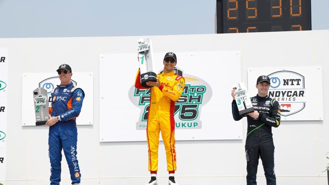 Kiwis Scott Dixon, left, and Marcus Armstrong, right, on the podium with winner Alex Palou after race two at Iowa Speedway. Photo / Getty Images