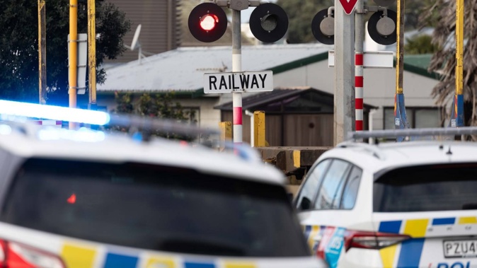 Police at the scene of the incident at the Hewletts Rd level crossing on Monday. Photo / Alex Cairns