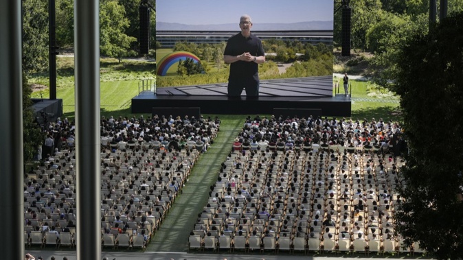 A large screen shows Apple CEO Tim Cook during an announcement of new products on the Apple campus in Cupertino, Calif., Monday, June 10, 2024. (AP Photo/Jeff Chiu)