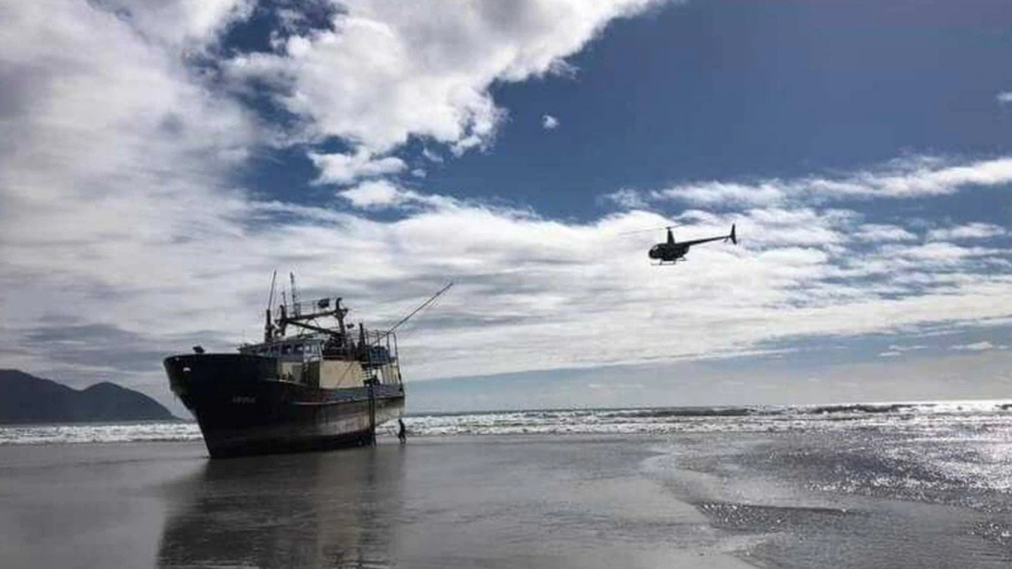 The fishing trawler RV Remus when it ran aground in March last year. The skipper has been fined $1500 for failing to report a serious injury on the boat two months earlier. Photo / Supplied