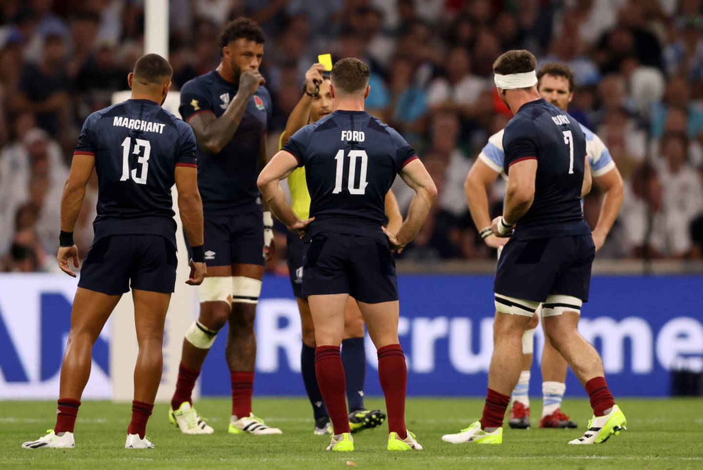 Tom Curry (right) of England is shown a yellow card by referee Mathieu Raynal. Photo / Getty Images