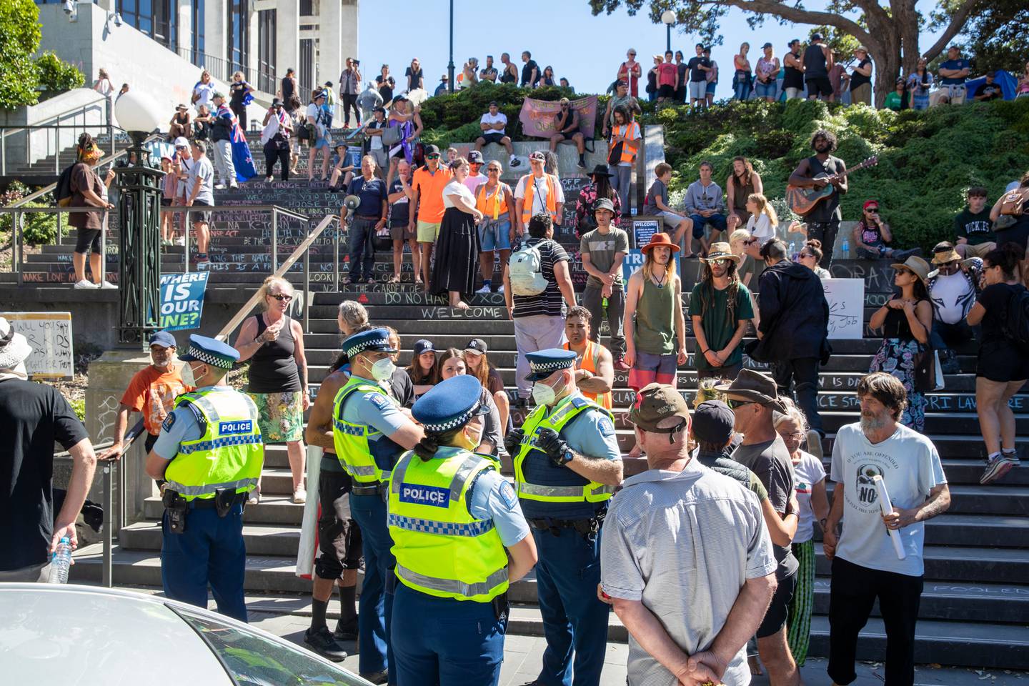 A crowd gathers to watch police on patrol at the anti-mandate protest and occupation at Parliament. (Photo / Mark Mitchell)