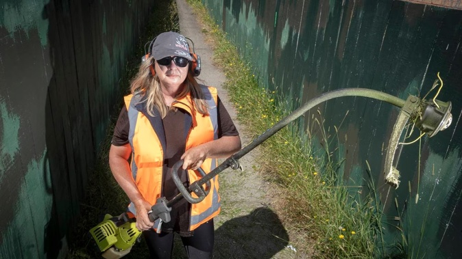Tracey McLeod has been out mowing overgrown grass on council land as her complaints to the council have fallen on "deaf ears". Photo / Andrew Warner