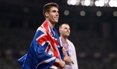 Gold medalist Hamish Kerr of Team New Zealand wears the national flag of New Zealand following the Men's High Jump Final on day four of the World Athletics Championships Tokyo 2025 at National Stadium on September 16, 2025 in Tokyo, Japan. (Photo by Hannah Peters/Getty Images)