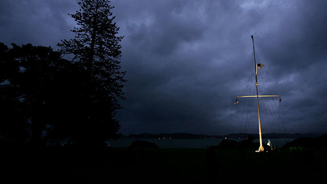 The flagstaff stands on the Treaty Grounds at dawn on Waitangi Day (Getty)