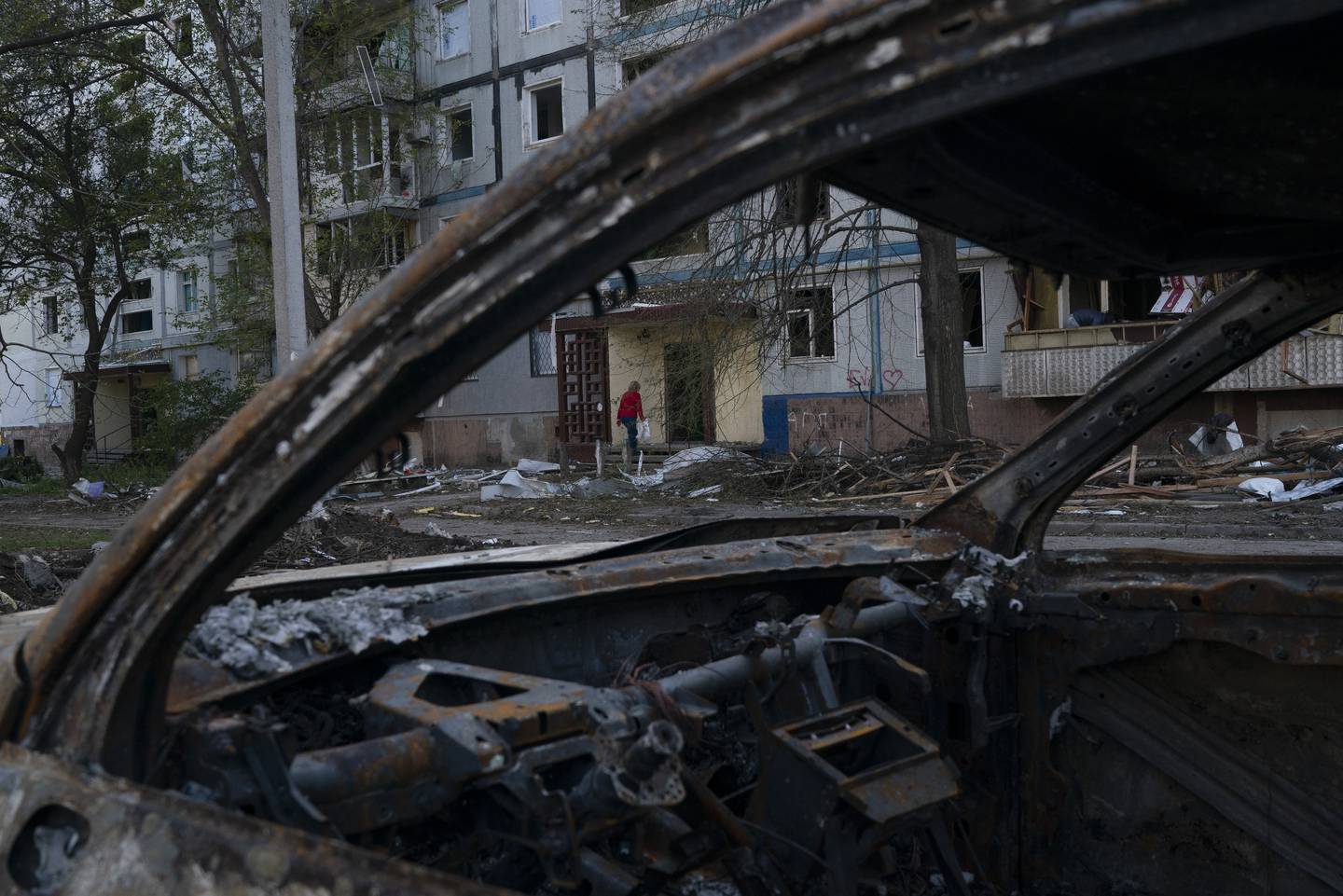 A woman enters a residential building that was heavily damaged after a Russian attack last week in Zaporizhzhia. Photo / Leo Correa, AP