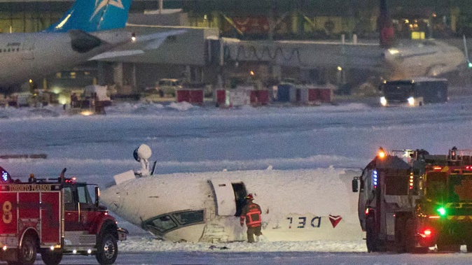 A Delta Air Lines jet with 80 people onboard crash-landed today at the Toronto airport. Photo / AFP