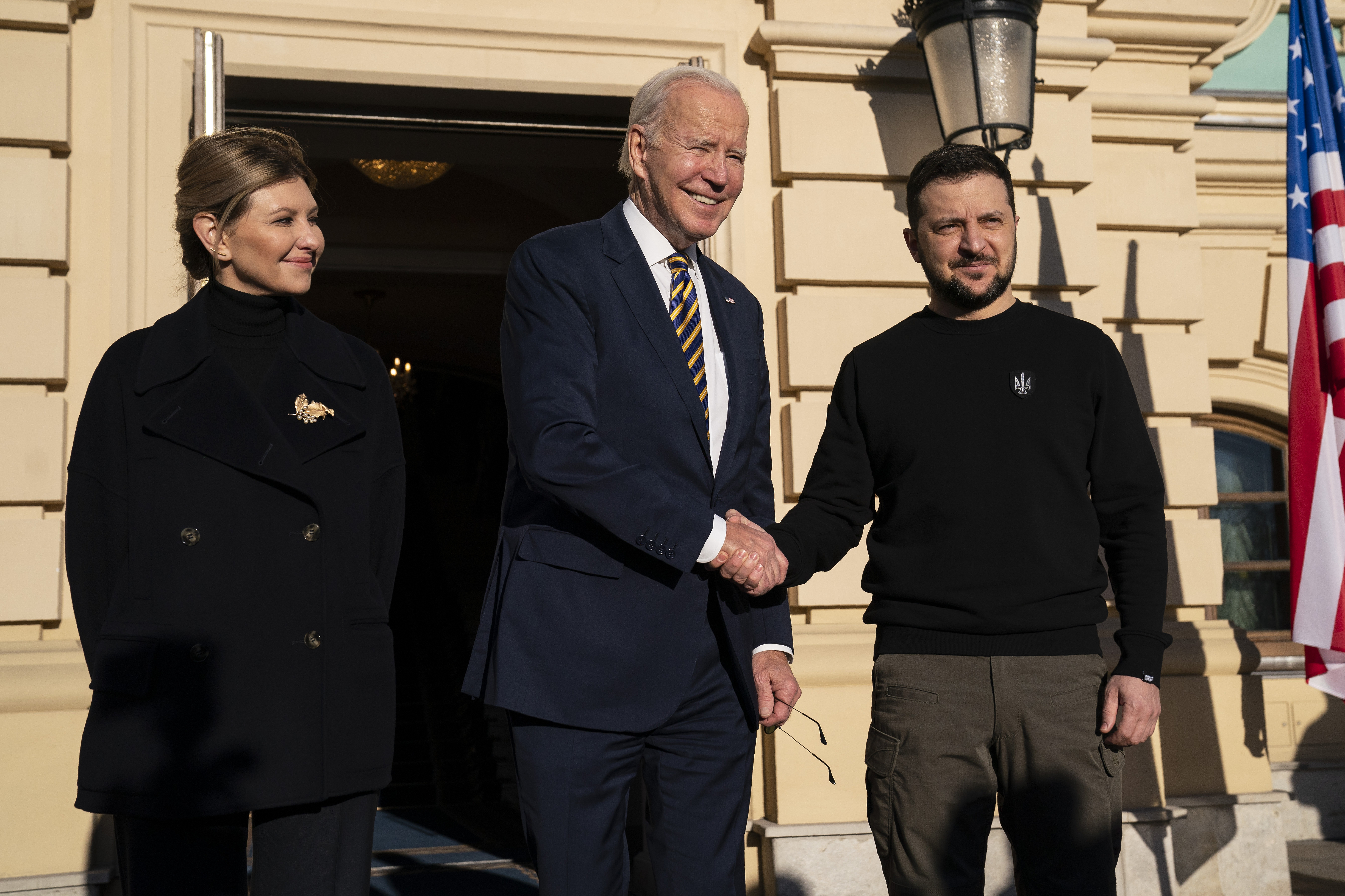 President Joe Biden, center, shakes hands with Ukrainian President Volodymyr Zelenskyy, right, as they pose with Olena Zelenska, left, spouse of President Zelenskyy, at Mariinsky Palace during an unannounced visit in Kyiv, Ukraine, Monday, Feb. 20, 2023.  Photo / AP
